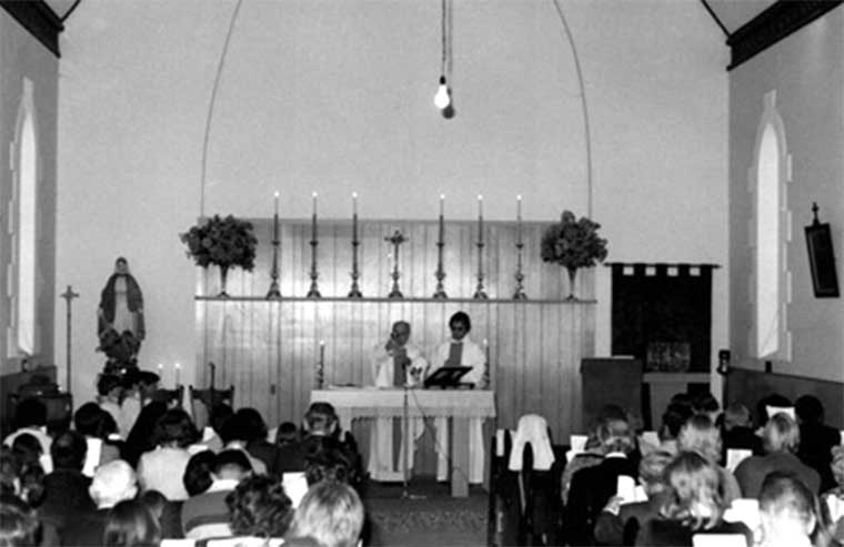 Brass candlesticks and Cross displayed on the shelf above the Altar in 1977